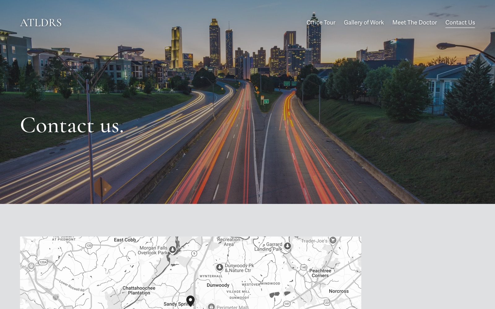 The Contact page: Contact us, over Atlanta traffic at dusk