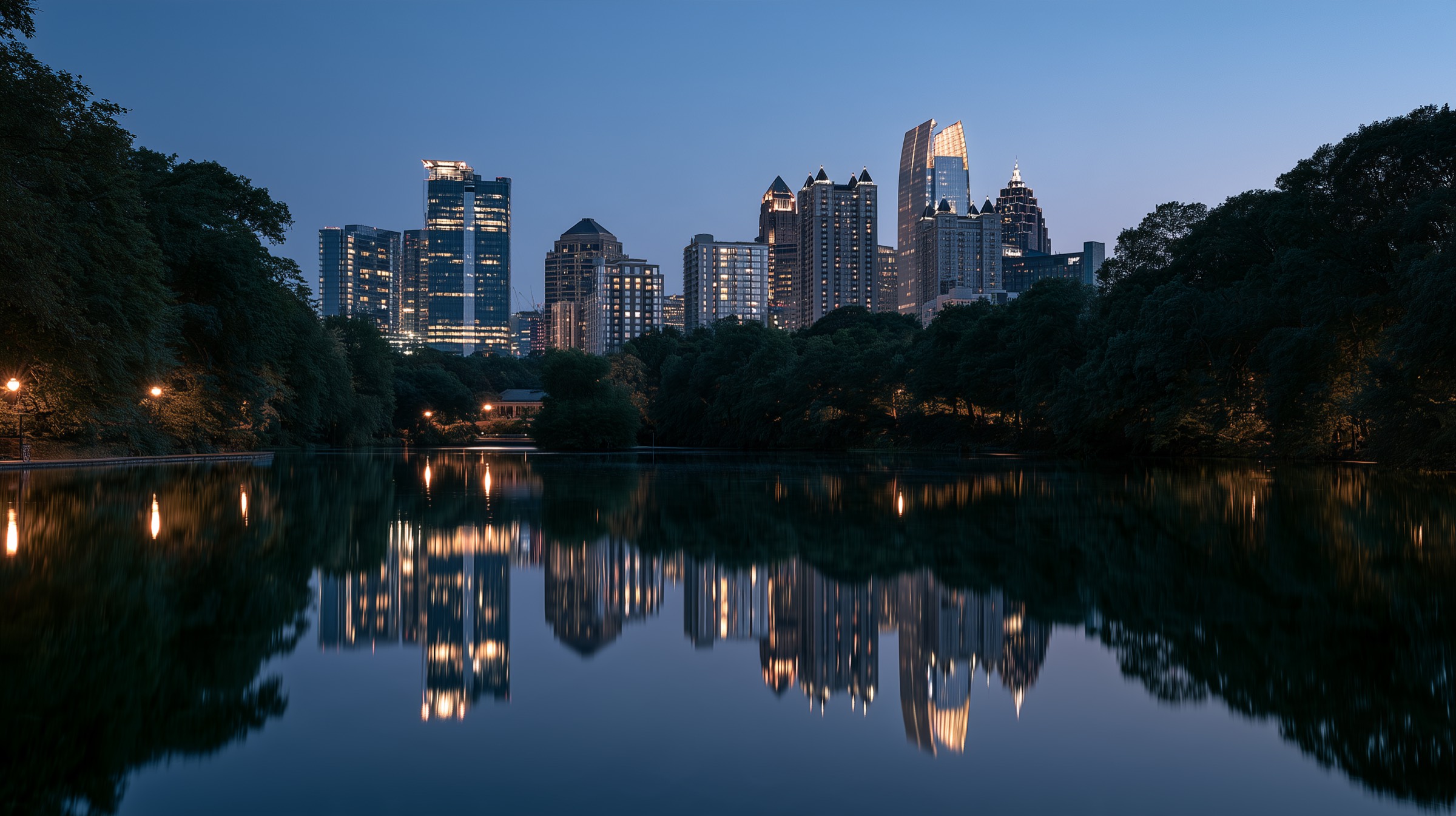 The Midtown Atlanta skyline at blue hour, reflected in a still lake
