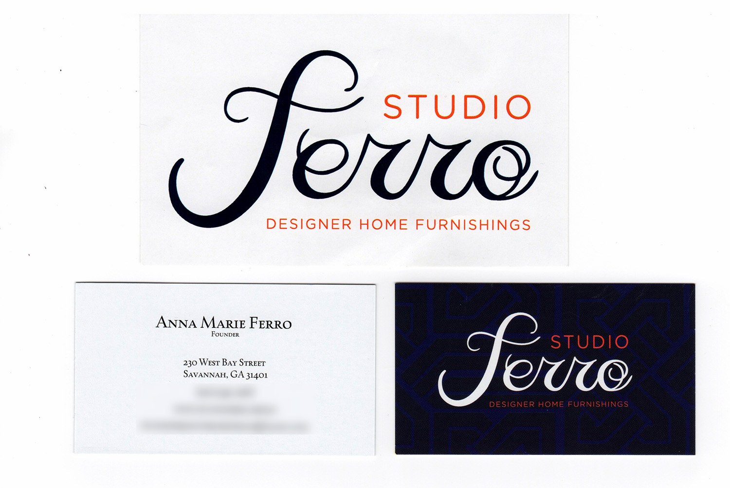 The printed Studio Ferro pieces: a large white card with the navy script wordmark, a details card for the founder on West Bay Street, and a navy card with the white script mark on the woven pattern
