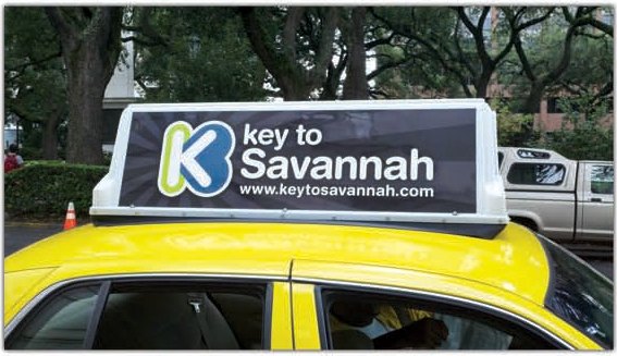 A yellow Savannah taxi with the Key to Savannah topper on its roof