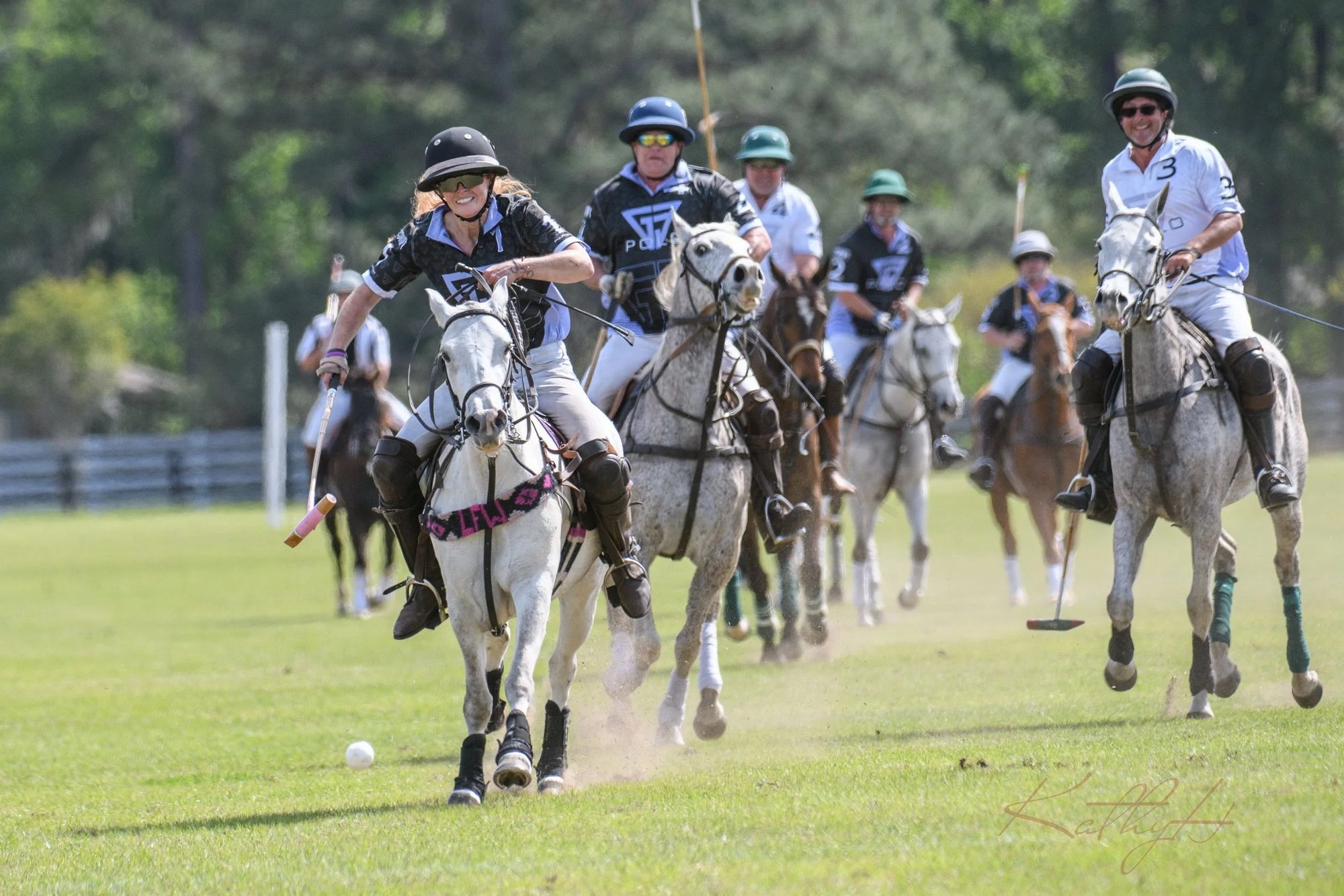 Polo players race down the field at the Spring 2023 Charity Polo Classic