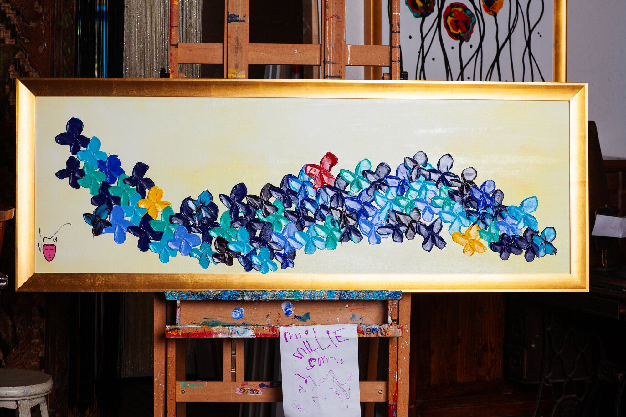 Vincent Golshani painting on an easel at Goldon House Gallery